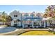 Charming two-story home featuring a covered porch, manicured landscaping, and inviting curb appeal at 518 Riverside Dr, Tarpon Springs, FL 34689