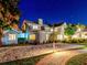 Exterior of home at night featuring beautiful landscape lighting and brick driveway at 518 Riverside Dr, Tarpon Springs, FL 34689