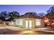 Charming property featuring well-manicured landscaping and a brick-paved driveway at 518 Riverside Dr, Tarpon Springs, FL 34689