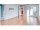 Bright, open living room boasts hardwood floors, white brick accent wall, and an open doorway to the kitchen at 518 Riverside Dr, Tarpon Springs, FL 34689