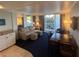 Living room with a sofa, dining table, and access to a balcony at 5500 Gulf Blvd # 2235, St Pete Beach, FL 33706