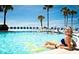 Personal relaxing in resort pool on sunny day at 5500 Gulf Blvd # 2237, St Pete Beach, FL 33706