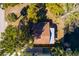 An aerial view shows the home's brown roof surrounded by lush trees and water features at 7176 Westwind St, Weeki Wachee, FL 34607
