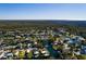 Stunning aerial view of the property nestled among canals in a wooded residential community at 7176 Westwind St, Weeki Wachee, FL 34607