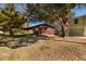 Charming single-story home with a cozy front porch, mature trees, and a well-maintained lawn at 7176 Westwind St, Weeki Wachee, FL 34607