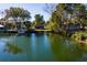 Picturesque water view showcasing the property's waterfront location amidst lush greenery and nearby docks at 7176 Westwind St, Weeki Wachee, FL 34607