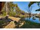 Lush backyard meets calm canal waters, with views of the boat dock, creating a tranquil waterfront setting at 7176 Westwind St, Weeki Wachee, FL 34607