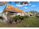 Spacious backyard with patio, tropical plants, and ample green space at 8370 Burgundy N Dr # 8370, Pinellas Park, FL 33781