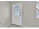 Entryway featuring a white door with a decorative glass window at 9739 Marlinton Ln, Port Richey, FL 34668