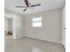 Bright bedroom with ceiling fan and tile flooring at 9739 Marlinton Ln, Port Richey, FL 34668