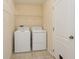 Laundry room with washer, dryer, and shelving at 13640 Eastfork Ln, Hudson, FL 34669