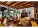 Living room with wicker furniture, hardwood floors, and a fireplace at 13801 Lake Village Pl, Tampa, FL 33618