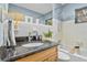 Bathroom with granite vanity and tiled shower/tub at 1480 N Russell Dr, St Petersburg, FL 33710