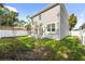 Landscaped backyard with a new home and a fenced area at 1815 E 22Nd Ave, Tampa, FL 33605
