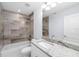 Bathroom with gray tile, granite countertop, and bathtub at 1815 E 22Nd Ave, Tampa, FL 33605