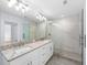 Modern bathroom with double vanity, granite countertops, and a large shower at 1815 E 22Nd Ave, Tampa, FL 33605