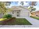Newly constructed home with gray siding, landscaping, and a two-car garage at 1815 E 22Nd Ave, Tampa, FL 33605