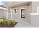 Charming front porch with a black door and white trim at 1815 E 22Nd Ave, Tampa, FL 33605