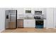 Sleek kitchen with stainless steel appliances and light wood flooring at 1815 E 22Nd Ave, Tampa, FL 33605