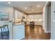 Modern kitchen with white cabinets, granite countertops, and hardwood floors at 2004 Sidney St, Clearwater, FL 33763