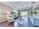 Bright living room with hardwood floors, comfy seating, and access to a patio at 2004 Sidney St, Clearwater, FL 33763
