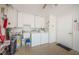 Laundry room with washer, dryer, and ample storage at 2739 Sherbrooke Ln # B, Palm Harbor, FL 34684