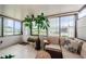 Sunroom with view, wicker furniture and potted plants at 2739 Sherbrooke Ln # B, Palm Harbor, FL 34684