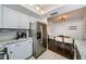 Modern kitchen with stainless steel appliances and white shaker cabinets at 2739 Sherbrooke Ln # B, Palm Harbor, FL 34684
