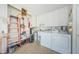 Functional laundry room with washer, dryer, and storage at 2739 Sherbrooke Ln # B, Palm Harbor, FL 34684