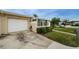 White garage door and driveway of tan house at 2739 Sherbrooke Ln # B, Palm Harbor, FL 34684