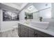 Bathroom with dual vanities and modern gray cabinets at 2739 Sherbrooke Ln # B, Palm Harbor, FL 34684