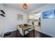 Bright dining area with glass top table and white chairs near kitchen at 2739 Sherbrooke Ln # B, Palm Harbor, FL 34684