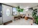 Bright sunroom with wicker furniture and many plants at 2739 Sherbrooke Ln # B, Palm Harbor, FL 34684