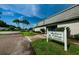 Clubhouse entrance with palm trees and signage at 2739 Sherbrooke Ln # B, Palm Harbor, FL 34684