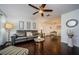 Open living area with hardwood floors, gray couch, and a dining area at 2739 Sherbrooke Ln # B, Palm Harbor, FL 34684