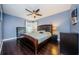 Well-lit bedroom, ceiling fan, and dark wood flooring at 2739 Sherbrooke Ln # B, Palm Harbor, FL 34684
