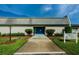 Community clubhouse with landscaping and signage at 2739 Sherbrooke Ln # B, Palm Harbor, FL 34684