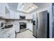 Modern kitchen with stainless steel appliances and white cabinets at 2739 Sherbrooke Ln # B, Palm Harbor, FL 34684