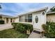 Front entrance of a tan house with white door at 2739 Sherbrooke Ln # B, Palm Harbor, FL 34684