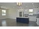Open concept kitchen featuring white cabinets and a center island at 3915 W Robson St, Tampa, FL 33614