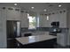 Modern kitchen with white cabinets, stainless steel appliances, and a large island at 3915 W Robson St, Tampa, FL 33614