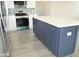 Kitchen island with white countertop and dark blue cabinetry at 3915 W Robson St, Tampa, FL 33614