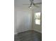Bright bedroom with ceiling fan, gray vinyl flooring, and white closet doors at 3915 W Robson St, Tampa, FL 33614