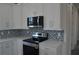 Modern kitchen with stainless steel appliances and blue backsplash at 3915 W Robson St, Tampa, FL 33614