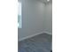 Simple bedroom with grey wood-look flooring and a window at 3915 W Robson St, Tampa, FL 33614