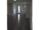 Bright and spacious living area with gray wood-look flooring and neutral walls at 3915 W Robson St, Tampa, FL 33614