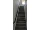 Modern staircase with sleek black railing and grey wood-look flooring at 3915 W Robson St, Tampa, FL 33614