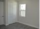 Bright bedroom with a window and white closet doors at 3915 W Robson St, Tampa, FL 33614