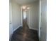 Hallway featuring wood-look tile flooring, white trim and doors, and access to storage at 3915 W Robson St, Tampa, FL 33614