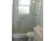 Modern bathroom with a glass shower, marble tile, and white vanity at 3915 W Robson St, Tampa, FL 33614